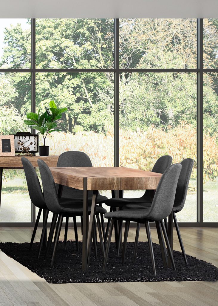 Industrial style wooden table with black metal legs and dark upholstered chairs.